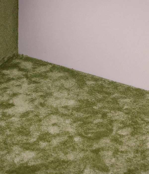 Cozy corner of a room with a yoga mat, plant, and soft light.