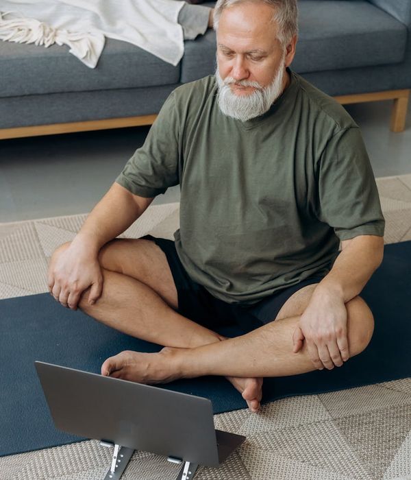 Person balancing on one leg in a yoga pose against a minimal background.